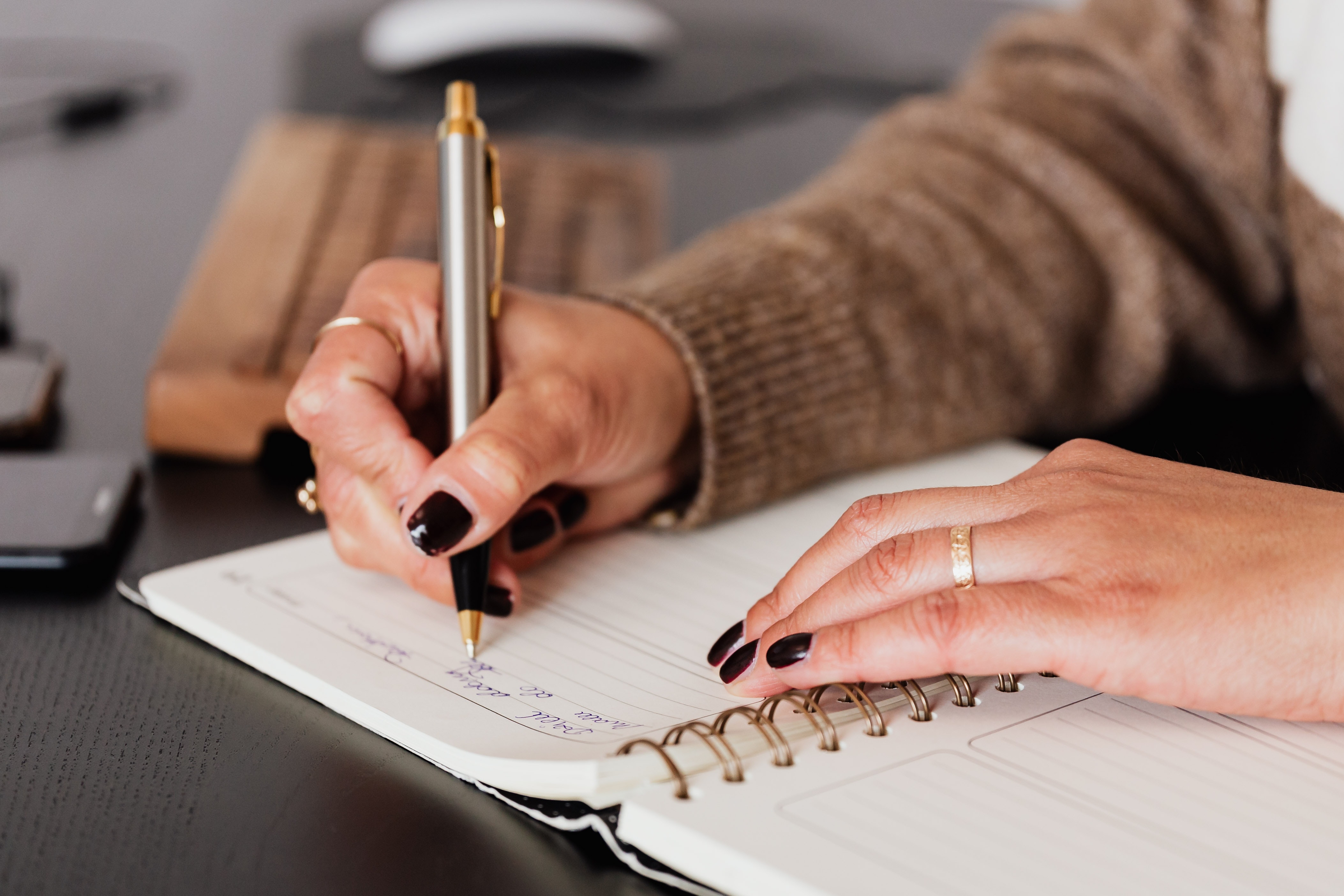a woman writing on a notepad